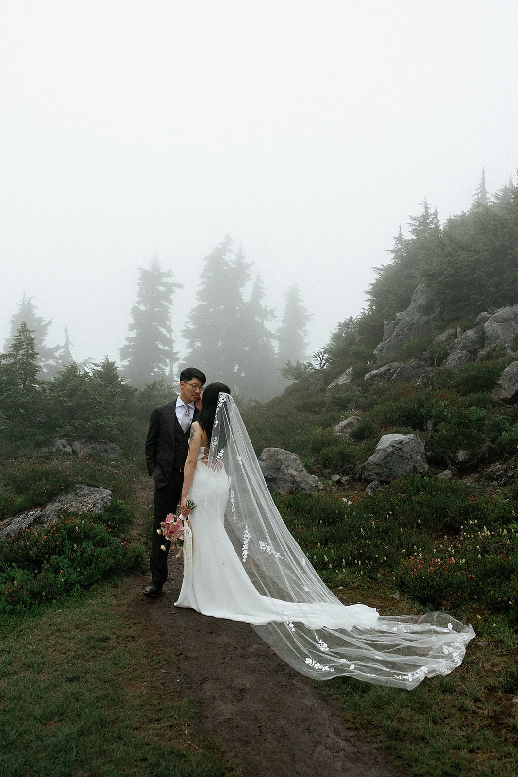 bride and groom on the redwood observation deck under their wedding arch of orange poppies